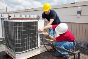 men fixing air conditioner