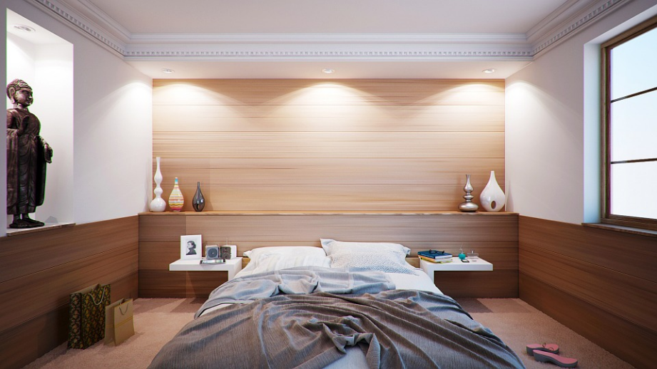 a nice bedroom with a messy bed